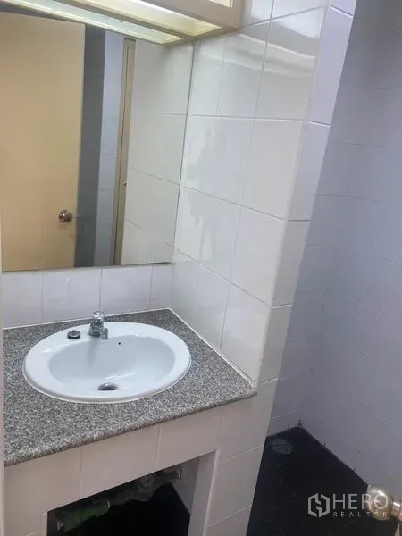 Office Space for rent in Watthana, Bangkok - Office bathroom with granite countertop vanity, mirror and tiled walls.