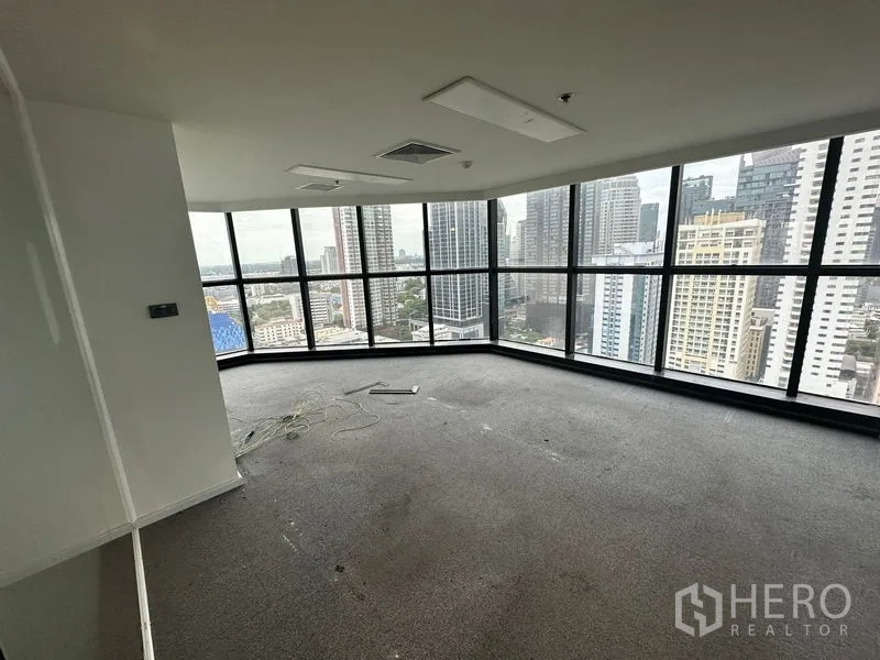 Office Space for rent - Corner office with panoramic skyline through wraparound floor-to-ceiling windows.