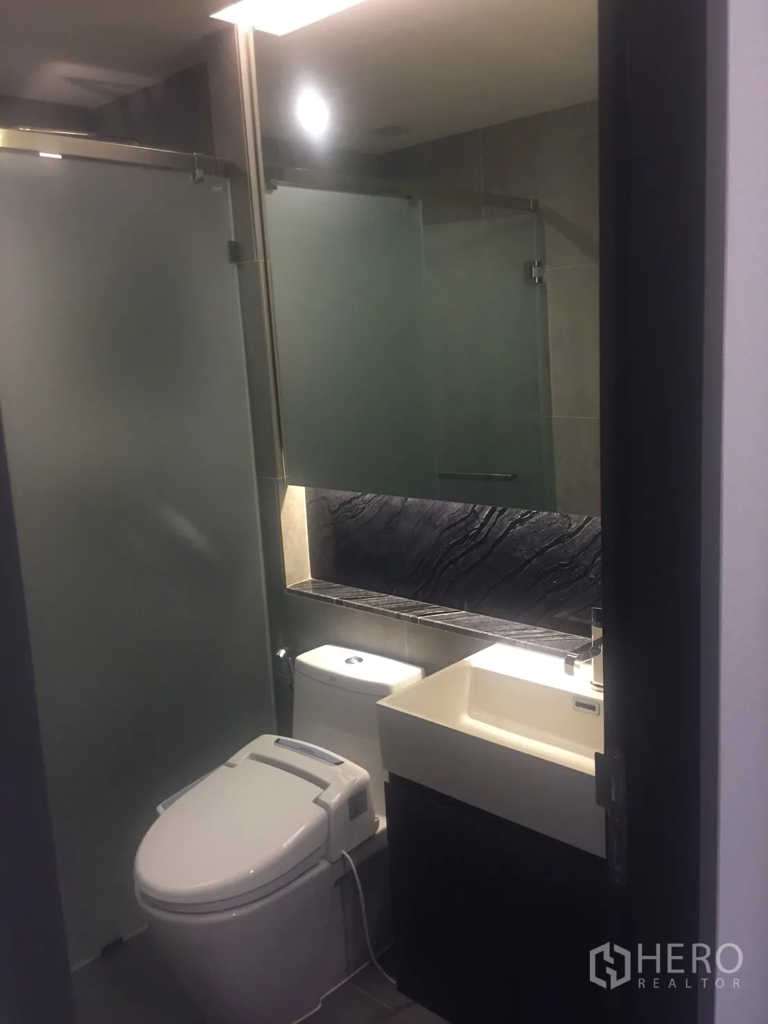 คอนโด ให้เช่าในKhlong Toei, Bangkok - ห้องน้ำสมัยใหม่พร้อมฉากกั้นอาบน้ำกระจกฝ้า อ่างล้างหน้า และโถสุขภัณฑ์ระบบชำระ