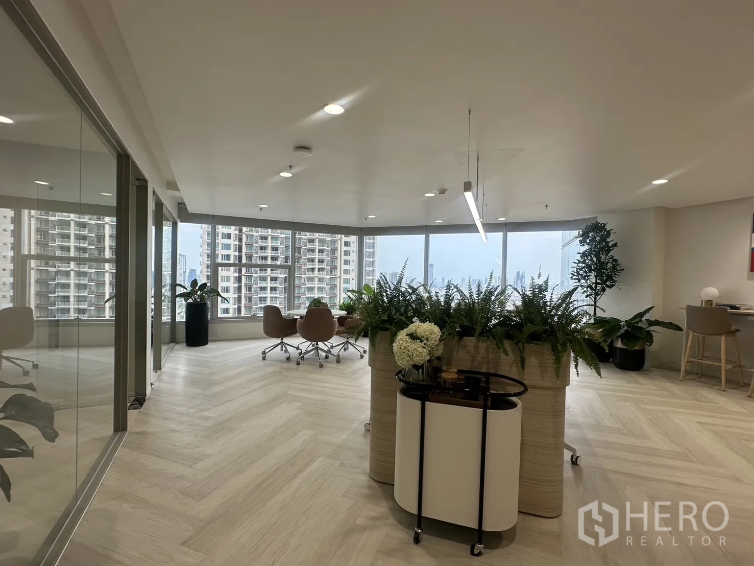 Office Space for rent in Sathon, Bangkok - Entrance area with planters, indoor greenery, and seating beside full-height windows.