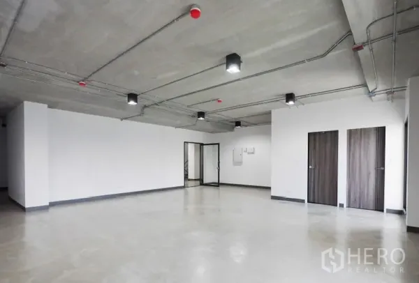 Office Space for rent in Khlong Toei, Bangkok - Open-plan 87 sqm office in Thonglor, Bangkok with polished concrete floor, exposed ceiling lighting, glass entry and two wooden doors.