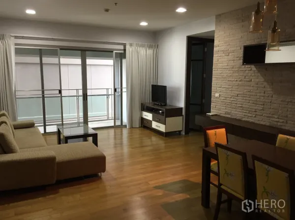 คอนโด ให้เช่าในWatthana, Bangkok - ห้องนั่งเล่นและทานข้าวพื้นไม้ พร้อมโซฟาเข้ามุม ตู้ทีวี และประตูบานเลื่อนออกสู่ระเบียง