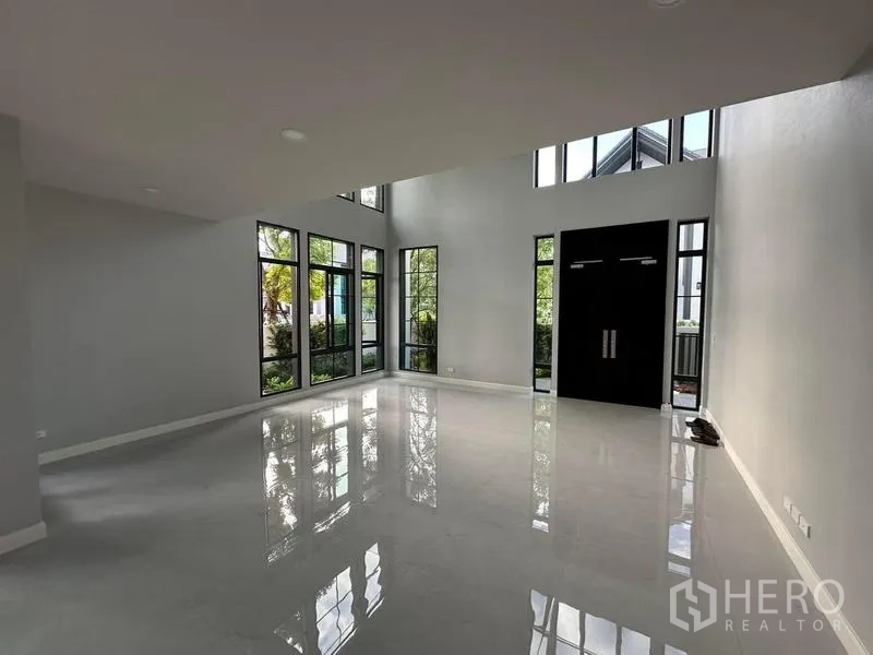 Detached House for rent or sale in Bang Phli, Samut Prakan - Open foyer and living area with tall windows and black double doors creating a grand entrance.