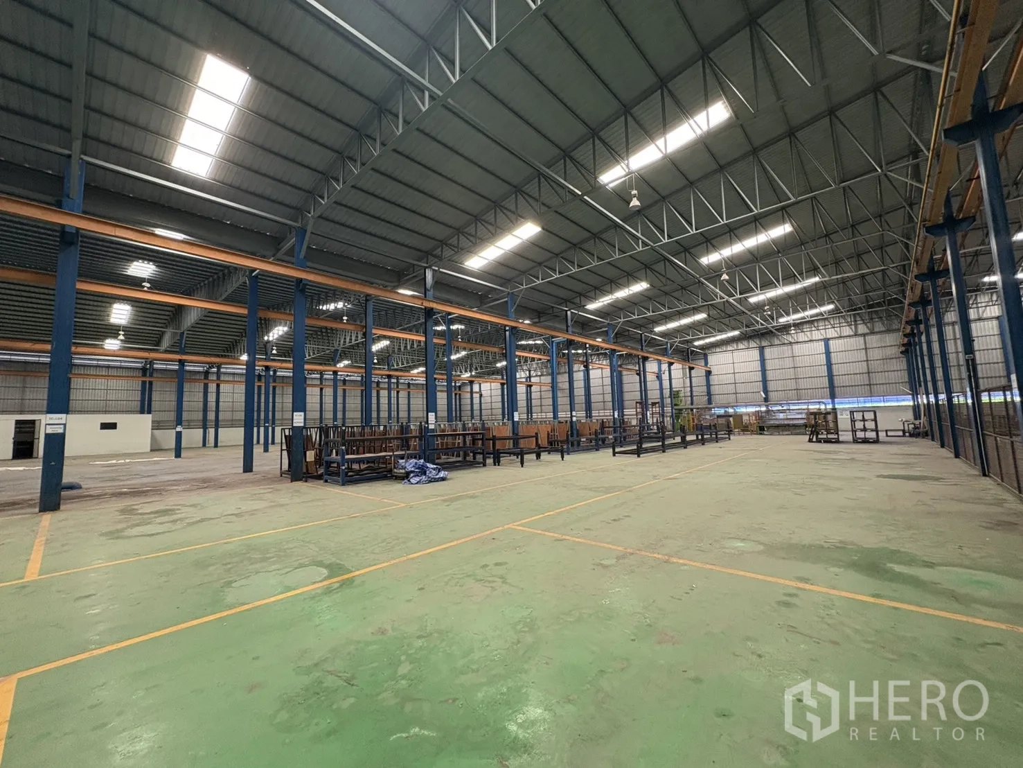 工厂 出租在Phra Pradaeng, Samut Prakan - 仓库内大面积绿色作业区，地面标线清楚。