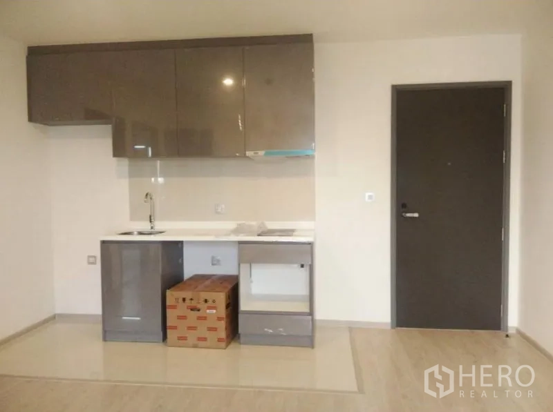 公寓 出售在Ratchathewi, Bangkok - 公寓内嵌厨房，亮面吊柜、洗槽与入户门