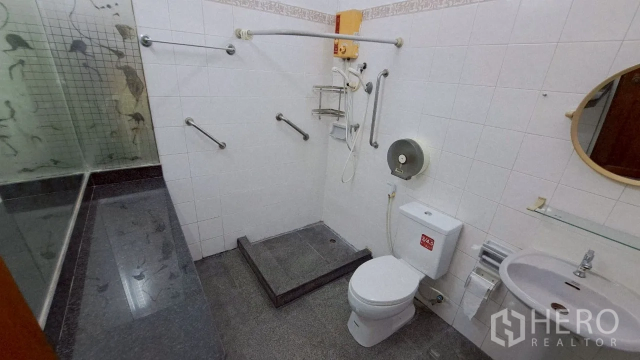 Townhouse for rent in Watthana, Bangkok - Second bathroom with walk-in shower, safety rails and vanity.