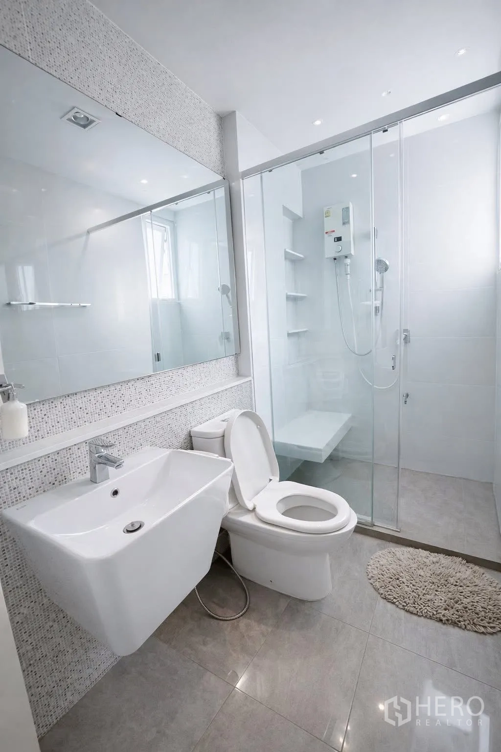 Detached House for rent or sale in Bang Phli, Samut Prakan - Modern white bathroom with large mirror and glass-enclosed shower.