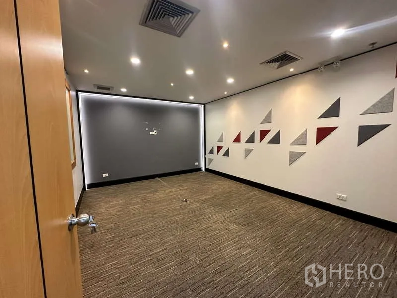 Office Space for rent in Khlong Toei, Bangkok - Modern meeting room with recessed lighting and geometric wall accents.