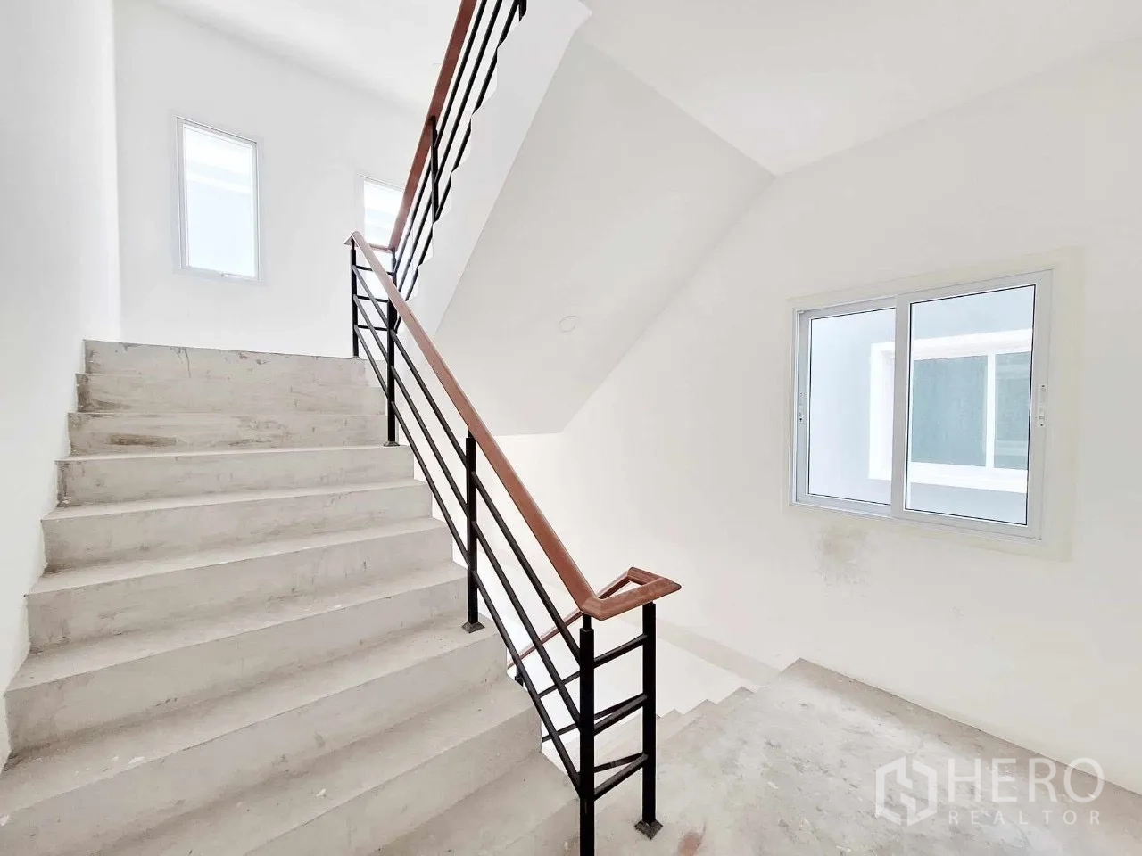 Office Space for sale in Bueng Kum, Bangkok - Bright stairwell with metal railing and side window.