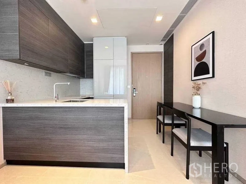Condominium for rent in Watthana, Bangkok - Modern kitchen with island, stone countertops and dining bench
