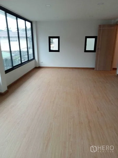 Home Office for sale - Bright room with a large window wall and small side windows.