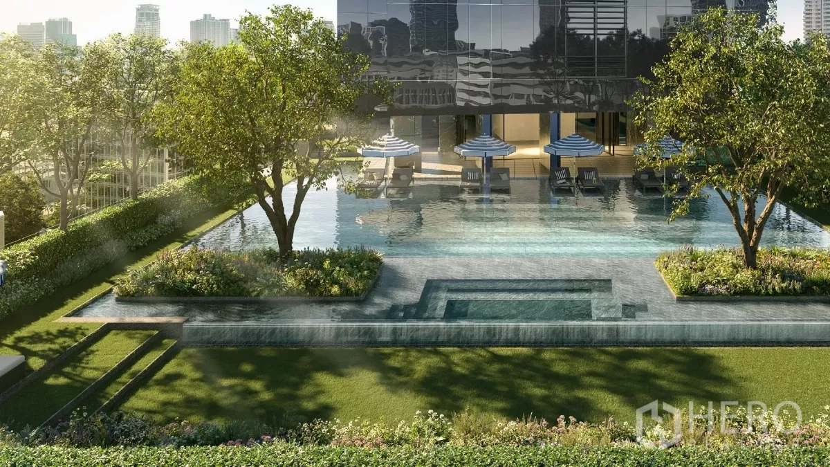 Apartment for rent in Khlong Toei, Bangkok - Sunlit outdoor swimming pool with sun loungers, umbrellas and landscaped gardens at a modern apartment in Bangkok.