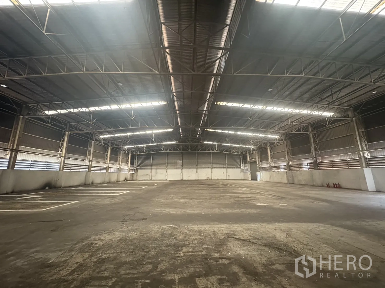 Factory for rent or sale in Samut Prakan - Restroom with tiled walls, two sinks and round mirrors.