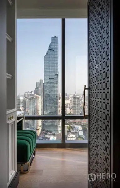 Condominium for rent in Bang Rak, Bangkok - View of the MahaNakhon tower from a windowed corridor with bench seating.