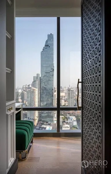 Condominium for rent in Bang Rak, Bangkok - View of the MahaNakhon tower from a windowed corridor with bench seating.