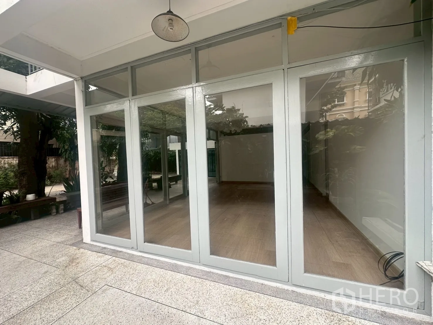 บ้าน ให้เช่าในWatthana, Bangkok - มุมภายนอกของผนังกระจกห้องนั่งเล่น เปิดสู่ลานพื้นหิน.