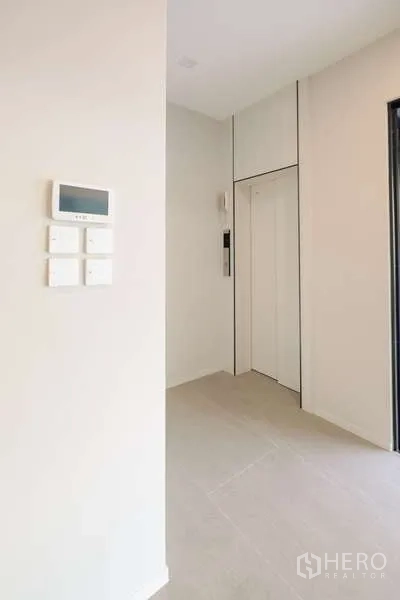 Detached House for rent in Saphan Sung, Bangkok - Private home elevator beside control panel in a clean hallway.