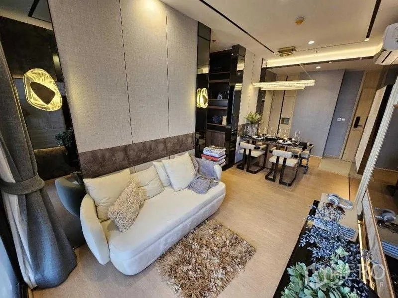 คอนโด ให้เช่า - ห้องนั่งเล่นคอนโดเอกมัยสไตล์โมเดิร์น โซฟาสีครีม พรม และมุมทานอาหาร