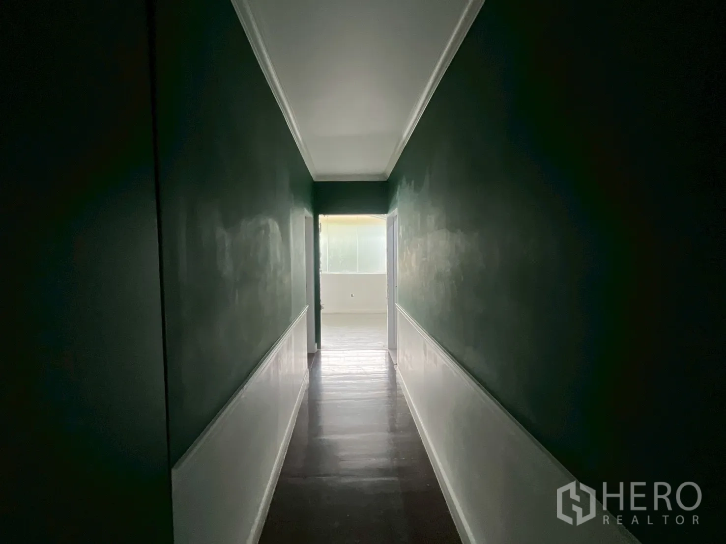 Office Space for rent in Watthana, Bangkok - Long corridor with dark green walls leading to a naturally lit room at the end.