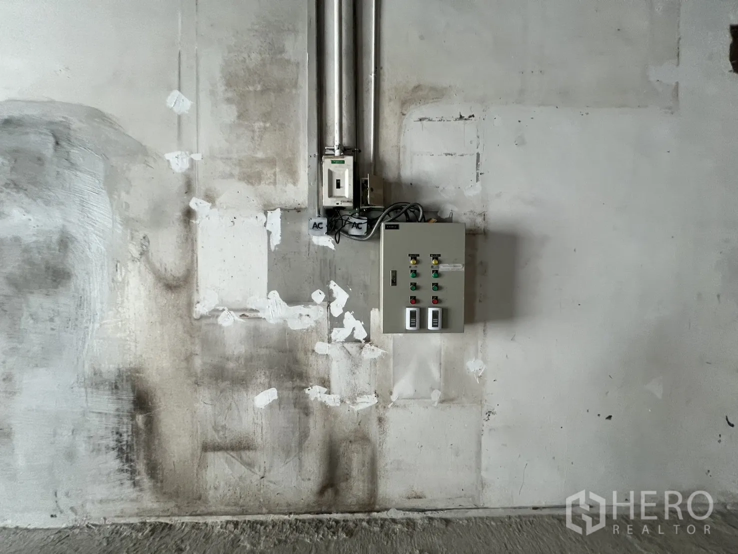 Retail Space for rent in Pathum Wan, Bangkok - Electrical switch box and conduits mounted on a patched wall.