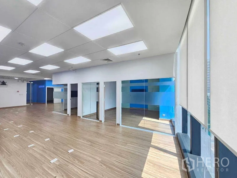 Office Space for rent in Sathon, Bangkok - Row of glass meeting rooms and full-height windows with roller blinds.