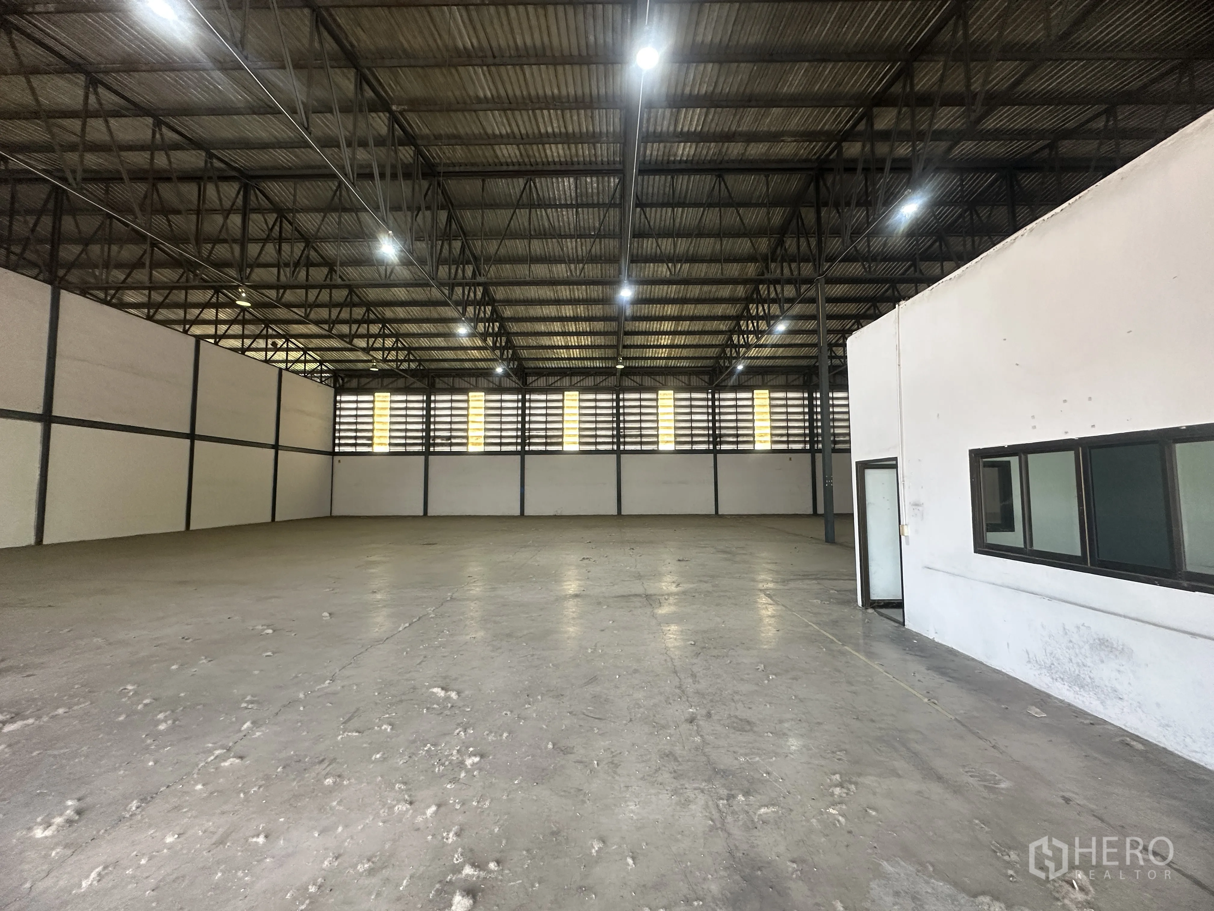 仓库 for rent in Khlong Luang, Pathum Thani - 仓库地面与内部带窗办公区的近景。