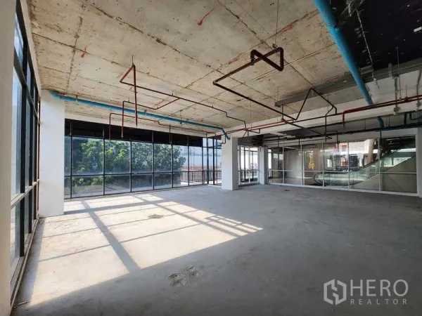 Retail Space for rent in Sathon, Bangkok - Retail unit beside escalator with wraparound glass facade, ready for tenant fit-out.