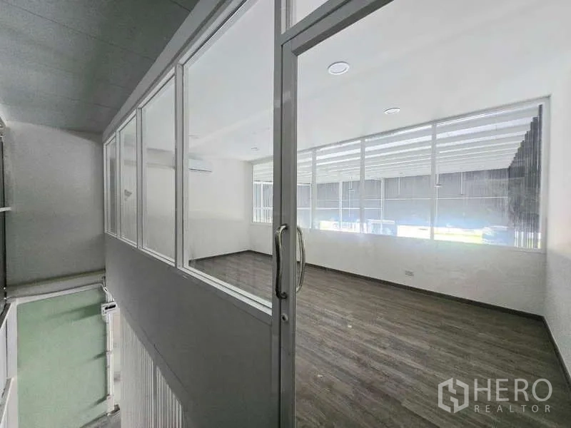 Warehouse for rent in Wang Thonglang, Bangkok - Sliding glass entry to the mezzanine office overlooking the warehouse floor.