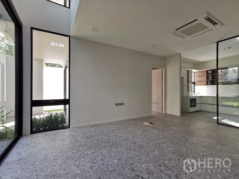 Detached House for sale in Saphan Sung, Bangkok - Ground floor living area with large glass doors and access to the kitchen.