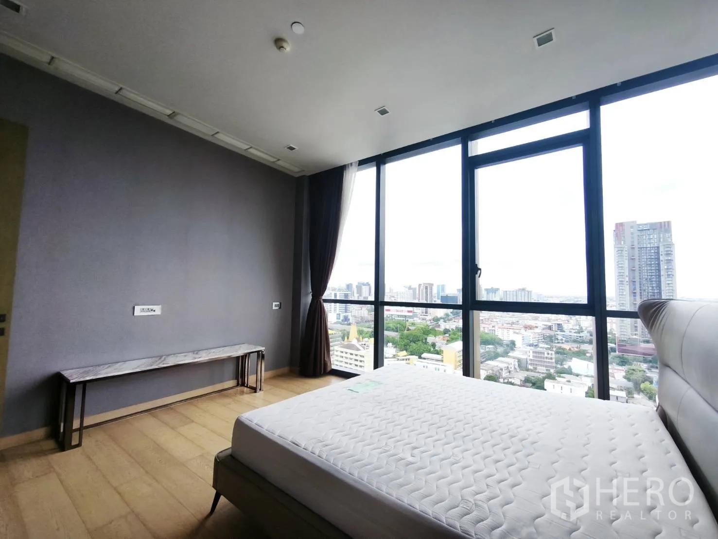 Condominium for rent in Watthana, Bangkok - Spacious bedroom with panoramic windows overlooking the city skyline.