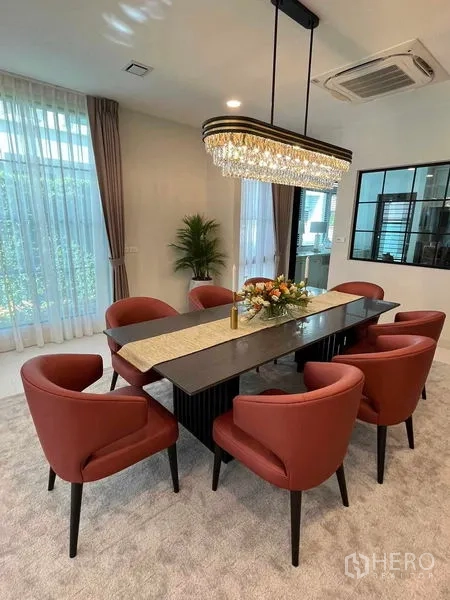 Detached House for rent in Saphan Sung, Bangkok - Dining room from another angle showing crystal chandelier, big windows and garden outlook.