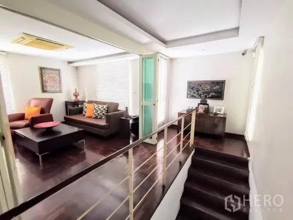 Detached House for rent or sale in Bang Phli, Samut Prakan - Upper floor family lounge with sofas, coffee table and staircase with metal railing.