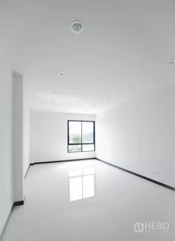 Factory for rent or sale in Nakhon Pathom - Long office room with recessed downlights and single end window.