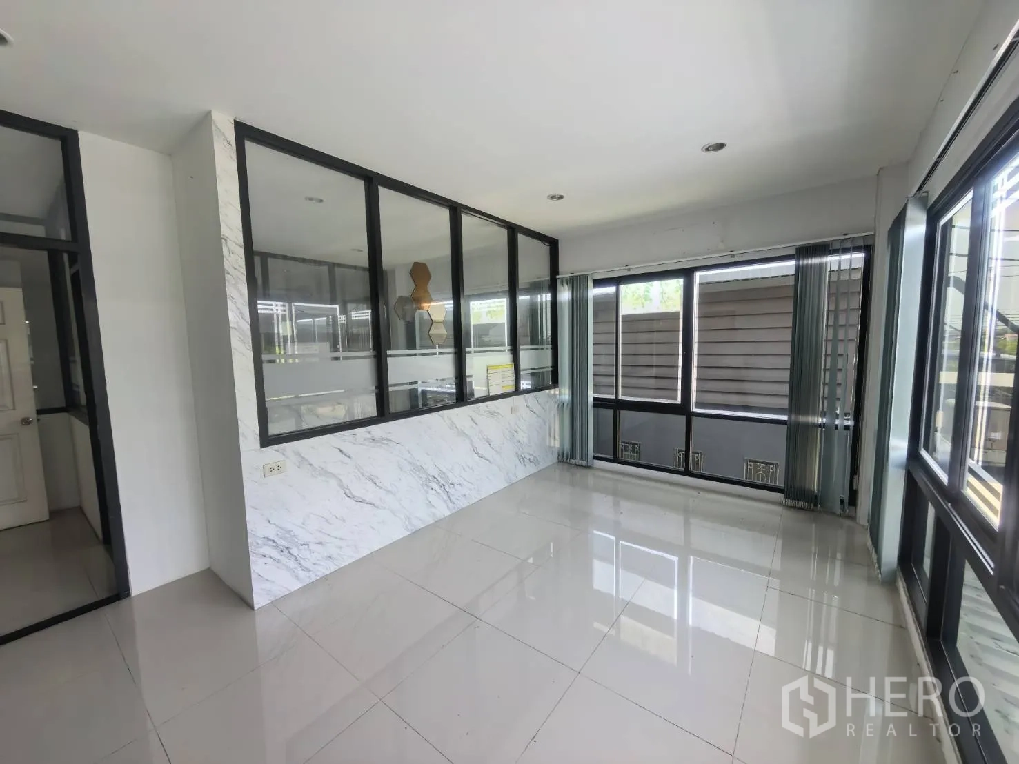Warehouse for rent in Bang Sao Thong, Samut Prakan - Bright office area with glass walls and multiple windows.