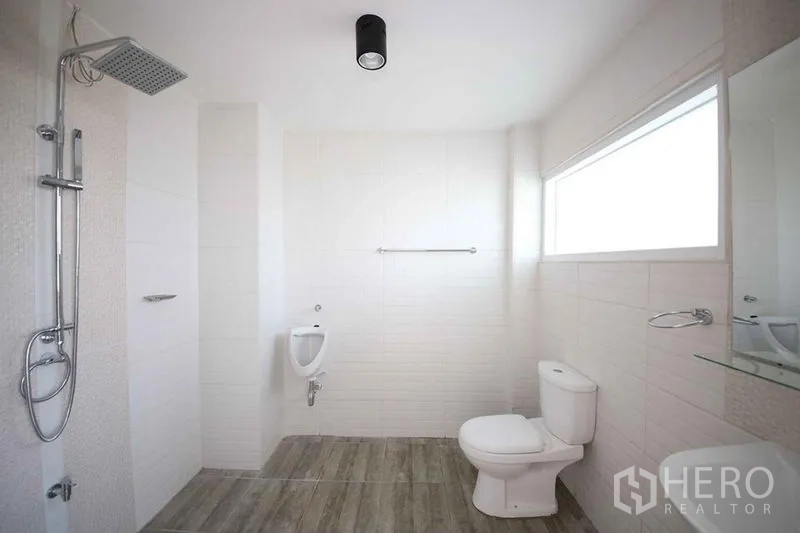 店屋 出租在Wang Thonglang, Bangkok - 现代化卫浴，顶喷花洒、坐便器与小便斗，配长窗。