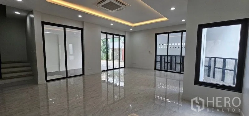 Home Office for rent in Khlong Toei, Bangkok - Large open space with sliding glass partitions and cove-lit ceiling.