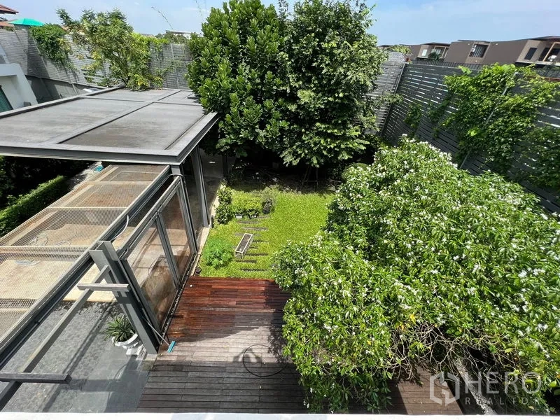 Detached House for sale in Bang Kapi, Bangkok - Aerial view of the private garden with trees and timber deck.