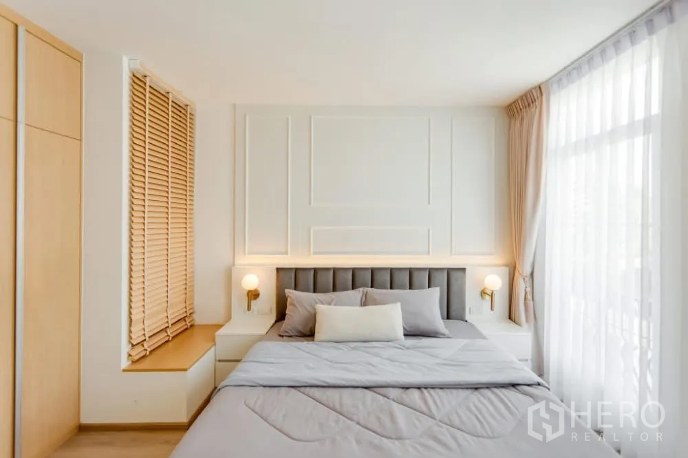 联排别墅 出租在Prawet, Bangkok - 卧室设软包床头、壁灯、飘窗座位与浅木色装饰。