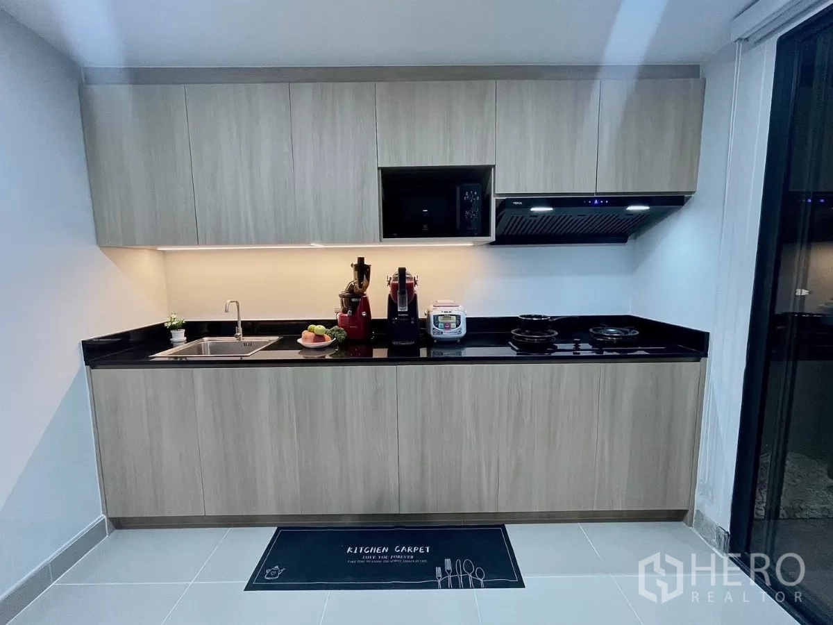 ทาวน์เฮาส์ ให้เช่าในSamut Prakan - ครัวบิวท์อินตู้ไม้ ท็อปหินสีดำ พร้อมไฟใต้ตู้