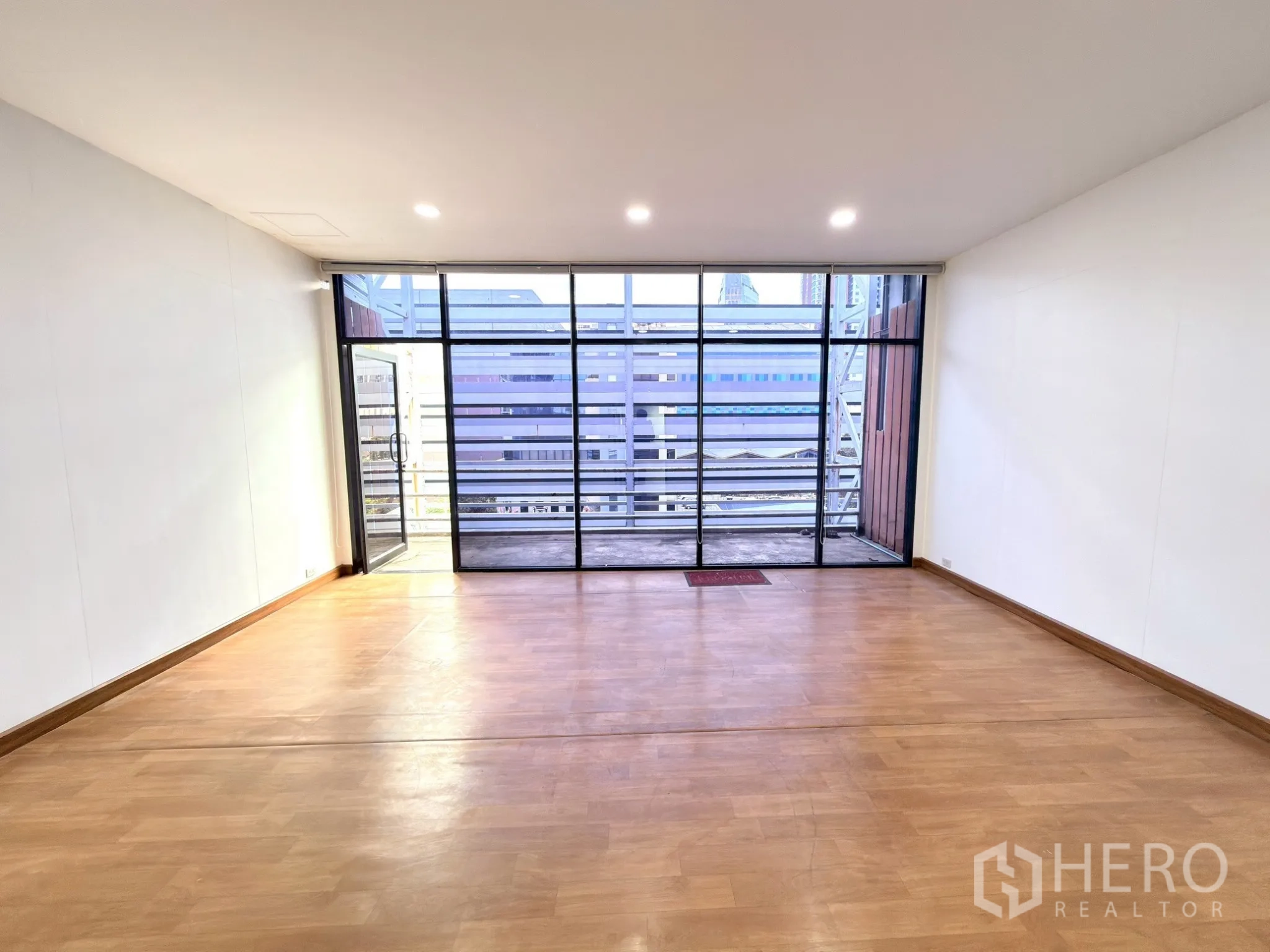 Office Space for rent in Watthana, Bangkok - Private room with floor-to-ceiling windows opening to a covered balcony and city outlook.