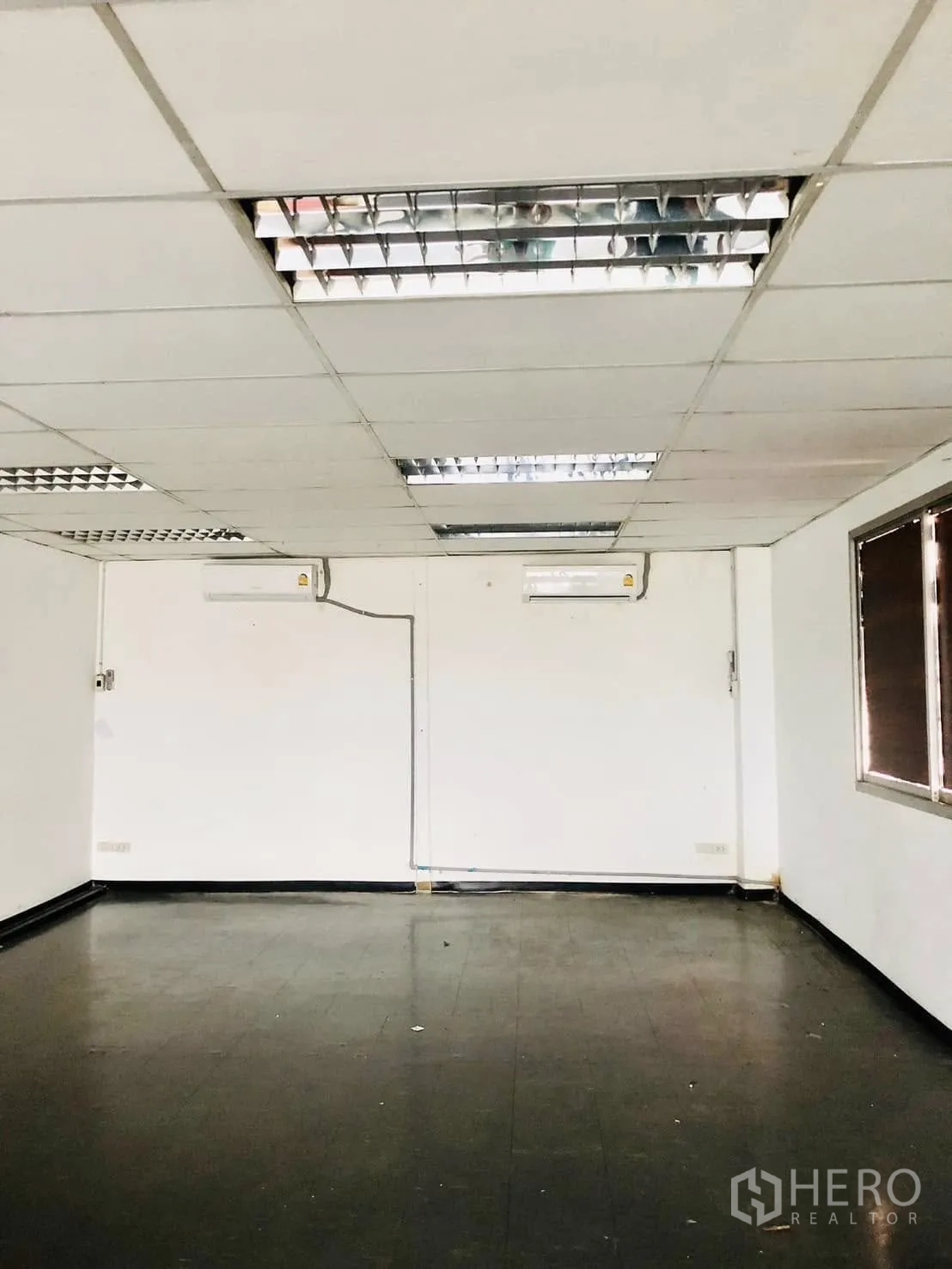 Office Space for rent in Lat Phrao, Bangkok - Unfurnished room with split-type air conditioners and dark flooring.
