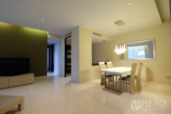Condominium for rent in Bang Rak, Bangkok - Open-plan living and dining space with TV cabinet and statement lighting.