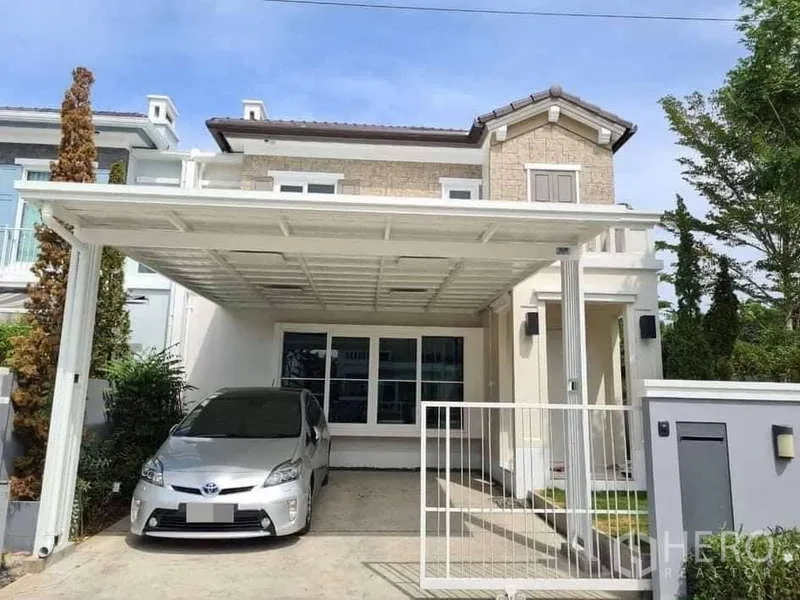 Detached House for rent in Prawet, Bangkok - Modern two-storey detached house with covered carport and gated entry.