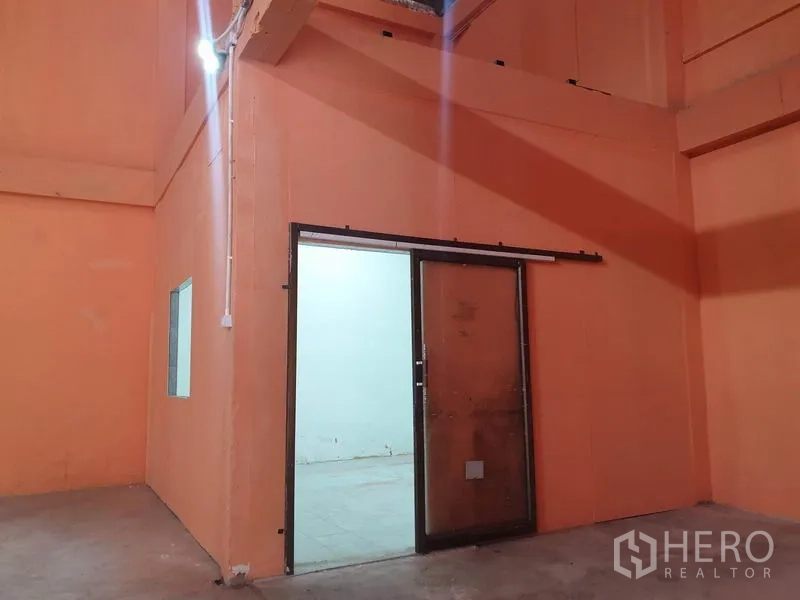 Warehouse for rent in Din Daeng, Bangkok - Internal office room with sliding glass door inside the warehouse.