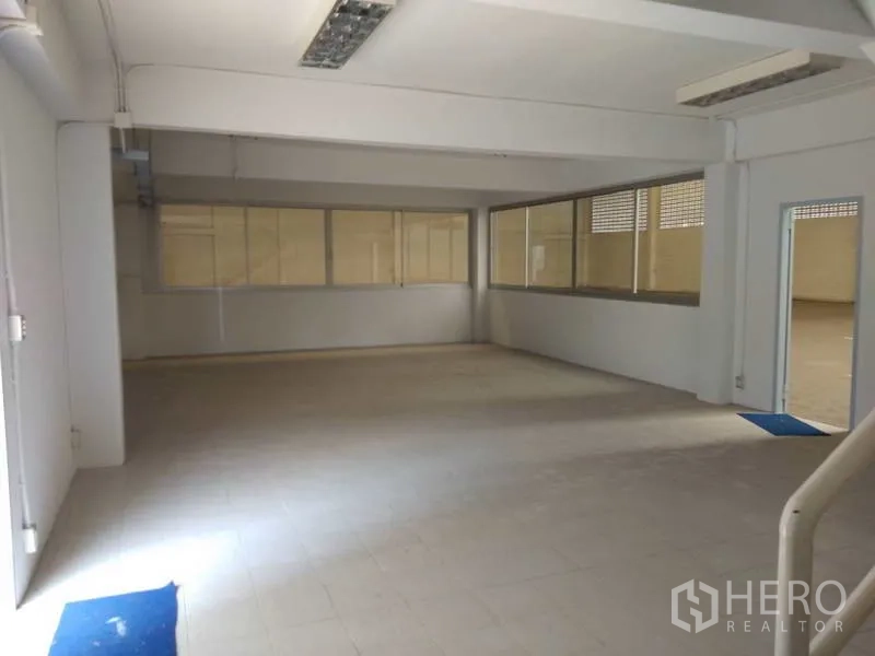 Warehouse for rent in Bang Phli, Samut Prakan - Ground-floor office or workspace with glass partitions facing the main warehouse area.