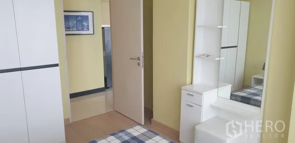 คอนโด ให้เช่าในKhlong Toei, Bangkok - ห้องนอนที่สองพร้อมตู้เสื้อผ้าสีขาว โต๊ะเครื่องแป้ง กระจก และพื้นไม้