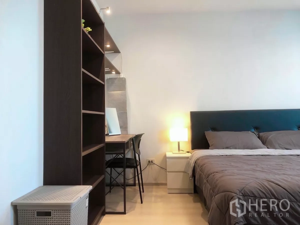 Townhouse for rent or sale in Bang Phli, Samut Prakan - Walk-in closet area with open wood shelves and dark curtains by the window.