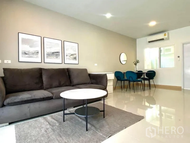 Townhouse for rent in Bang Phli, Samut Prakan - Open-plan living and dining area with air conditioning and abundant natural light.