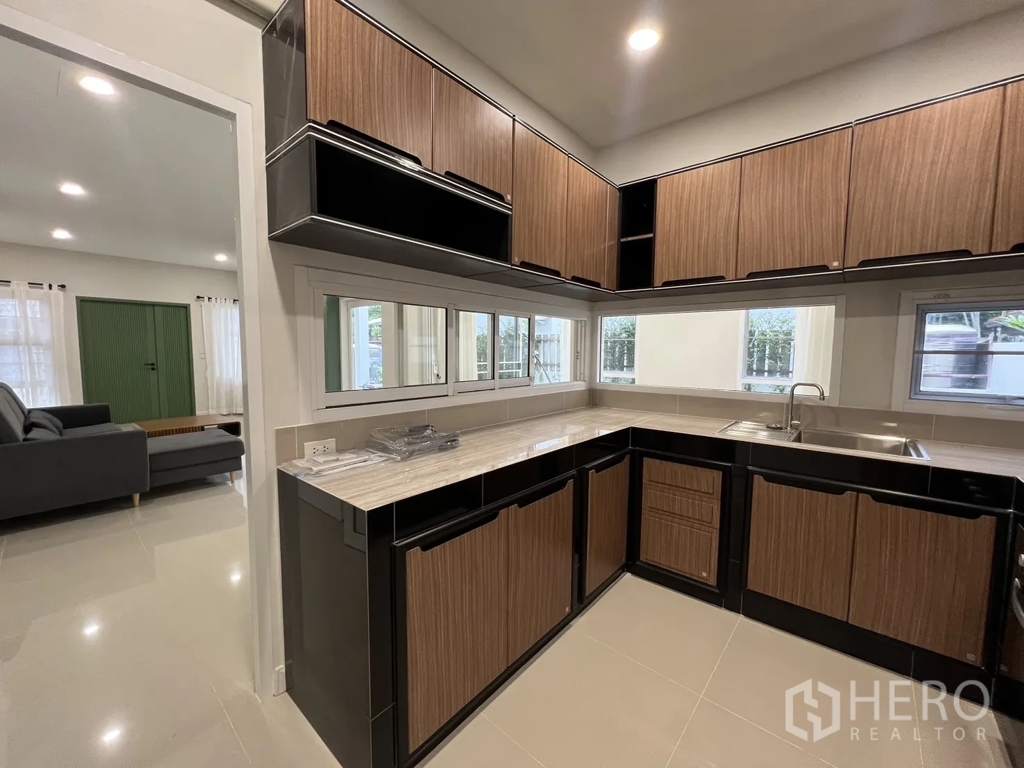 Detached House for rent in Saphan Sung, Bangkok - Kitchen view toward living room with long window backsplash.
