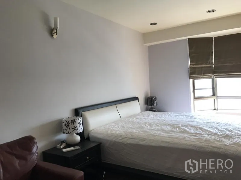 Condominium for rent in Watthana, Bangkok - Master bedroom with king bed, bedside tables and window blinds letting in natural light.